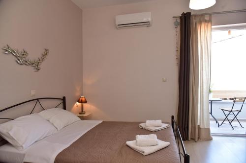 a bedroom with a bed with two towels on it at Rooms Kochilas Elafonisi in Elafonisi