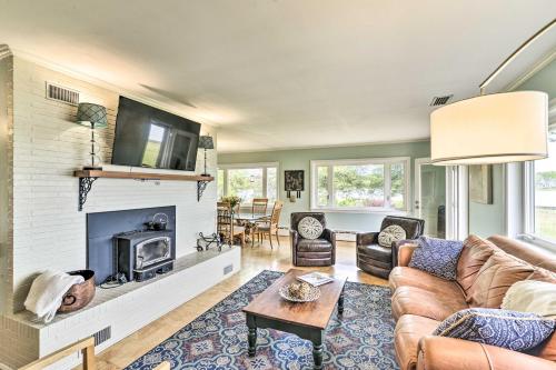 a living room with a couch and a fireplace at Bayfront Retreat with Game Room and Outdoor Pool! in Exmore