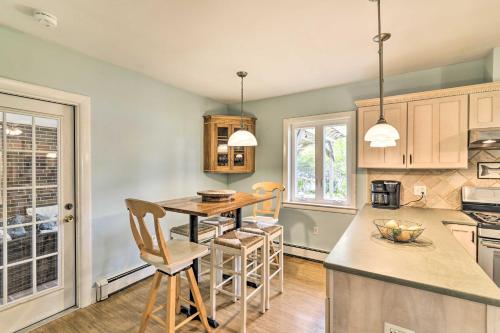 a kitchen with a table and chairs in it at Bayfront Retreat with Game Room and Outdoor Pool! in Exmore