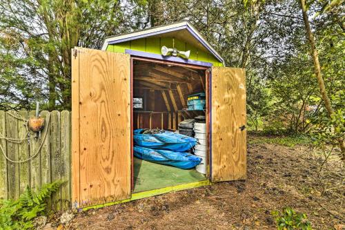 a wooden outhouse with a door in a fence at Bayfront Retreat with Game Room and Outdoor Pool! in Exmore