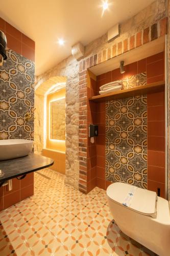a bathroom with a white toilet and a sink at Domus Maritima in Trogir