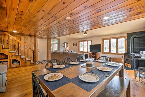 a dining room with a large wooden table with chairs at Cozy Castleton Cabin with Fire Pit and Water Access! in Castleton