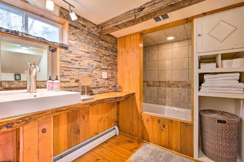 a bathroom with a sink and a shower at Cozy Castleton Cabin with Fire Pit and Water Access! in Castleton