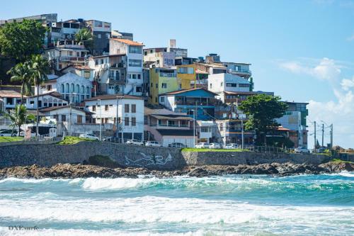 a group of houses on a hill next to the ocean at Hostel Recanto da Sereia in Salvador
