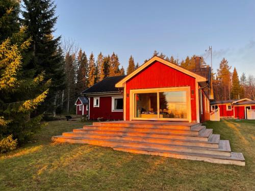 a red house with steps leading up to it at Beautiful house in the nature with private river access in Luleå