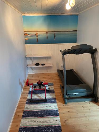 a room with a bedroom with a bed and a table at Beautiful house in the nature with private river access in Luleå