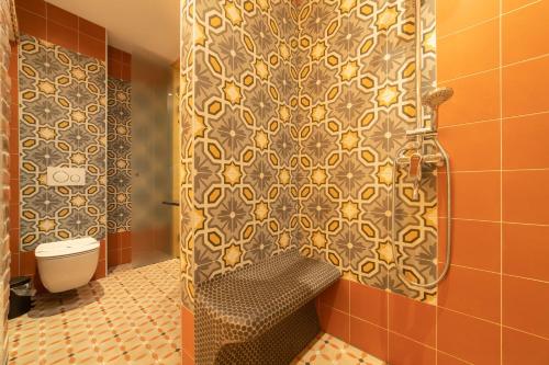 a bathroom with a shower with a bench and a toilet at Domus Maritima in Trogir