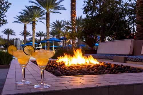 two cocktails on a table in front of a fire pit at Club Wyndham Desert Blue in Las Vegas