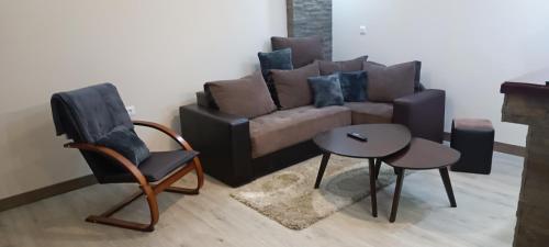 a living room with a couch and two chairs and a table at Tajna037 in Kruševac