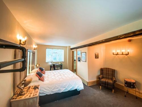 1 dormitorio con cama, escritorio y silla en The Bridge at Riverside Suites en Bridgnorth