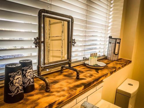 een badkamer met een wastafel en een spiegel op een aanrecht bij The Bridge at Riverside Suites in Bridgnorth