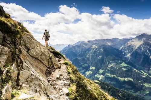 a man standing on the edge of a mountain at Ferienhaus Bergler Hoamat in Navis
