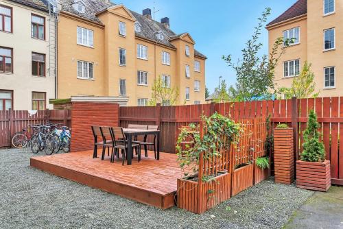a patio with a table and chairs and a fence at Cozy room in City center in Trondheim