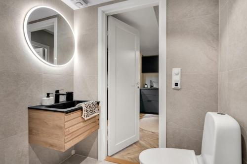 a bathroom with a sink and a mirror at Cozy room in City center in Trondheim