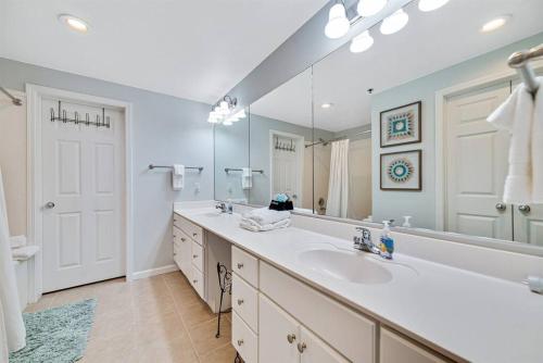 a bathroom with a sink and a large mirror at Bristol 205 - Beachfront Condo with Breathtaking Views in Gulf Shores