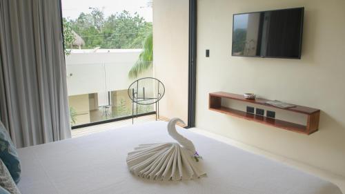 a sculpture of a swan on a table in a room at Moonshine Tulum Hotel & Hostel in Tulum