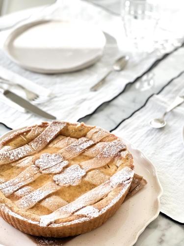 a pie sitting on a plate on a table at CinziaHome Boutique B&B Spiaggia Privata in Lido di Fermo