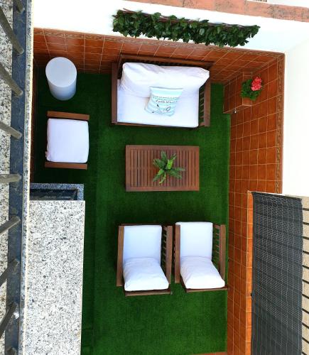 a house with two white chairs on a patio at Casa Maria in Olivenza