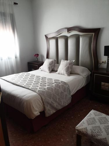 a bedroom with a large bed with two pillows at Casa Maria in Olivenza