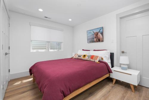 a bedroom with a large bed with a purple blanket at New Mountain Retreat with Hot Tub & Putting Green in Heber City