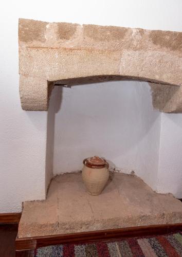 a vase sitting on a shelf in a room at Goulas Traditional Guesthouse in Monemvasia