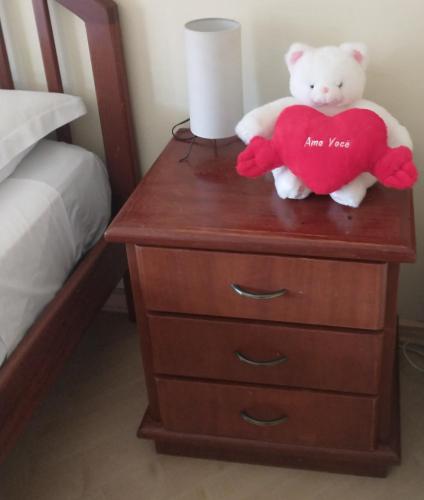 a teddy bear holding a heart on a dresser at Casarão Primavera in Serra Negra