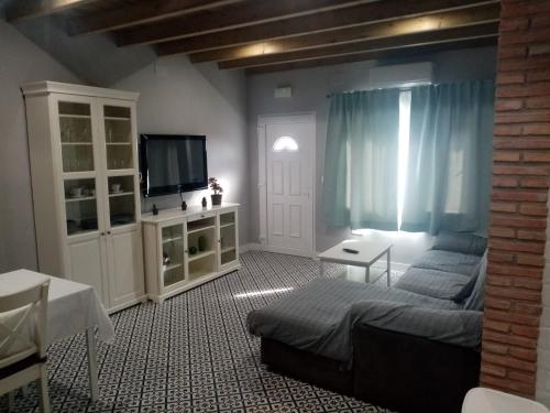 a bedroom with a bed and a tv in a room at Casa Rural La Plata in Aljucén