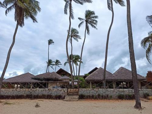 a resort on the beach with palm trees at CUMBUCO - Eco Paradise - AP 112 in Caucaia