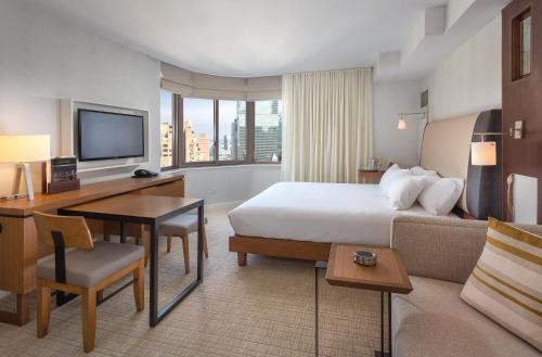 a hotel room with a bed and a desk at Club Wyndham Midtown 45 in New York