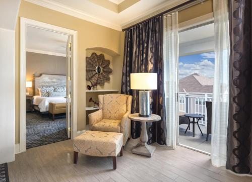 a room with a bed and a chair and a window at Club Wyndham Nashville in Nashville