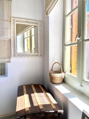 a bench in a room with a mirror and a basket at Traditional Stone House in Chandrinos in Khandrinós