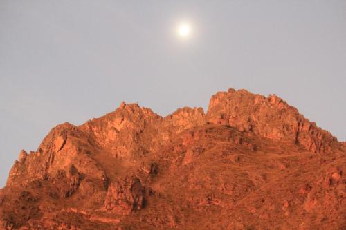 a mountain with the moon on top of it at Killari B&B in Ollantaytambo