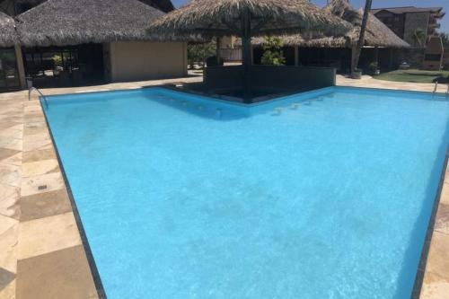a swimming pool with blue water in a resort at CUMBUCO - Eco Paradise - AP 112 in Caucaia