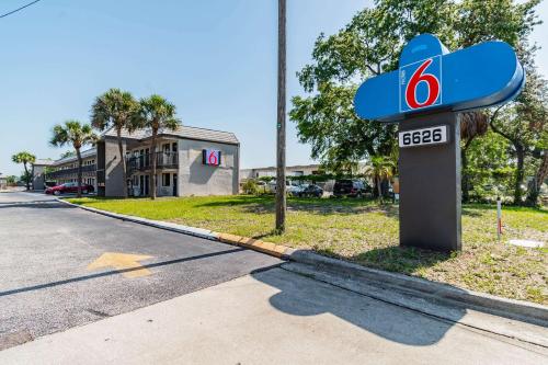 a blue gas station sign on the side of a road at Motel 6 Tampa Near Fairgrounds - Casino in Tampa