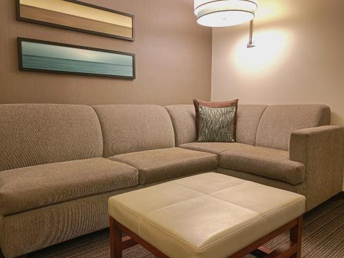 a living room with a couch and a table at Hyatt Place San Jose Pinares in San José