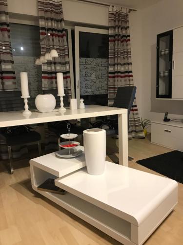 a white table with two white vases on it at Student Homestay in Im Teller