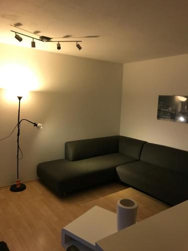 a living room with a couch and a lamp at Student Homestay in Im Teller