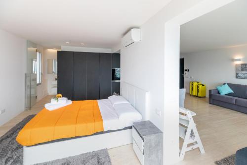 a bedroom with a large bed and a couch at Mont des Olives - Cap D'ail- app6 in Saint-Antoine