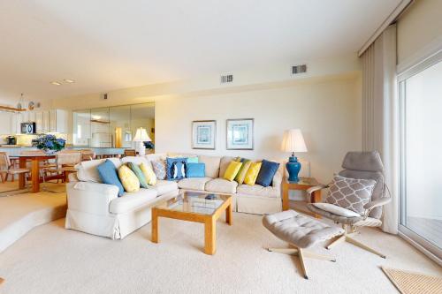 a living room with a white couch and a table at Seaside Villas --- 40123 Seaside Drive in Fenwick Island