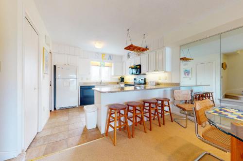 a kitchen with a table and chairs and a counter at Seaside Villas --- 40123 Seaside Drive in Fenwick Island