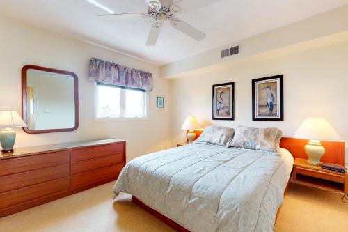 a bedroom with a bed and a large mirror at Seaside Villas --- 40123 Seaside Drive in Fenwick Island