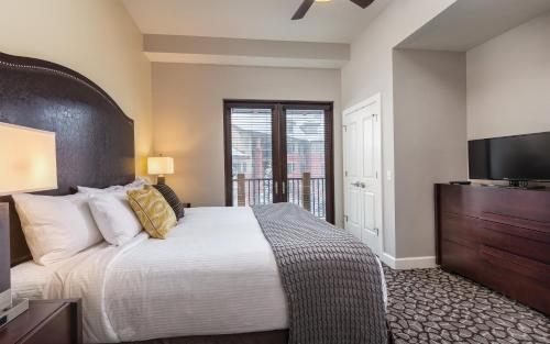a bedroom with a large bed and a flat screen tv at Club Wyndham Park City in Park City
