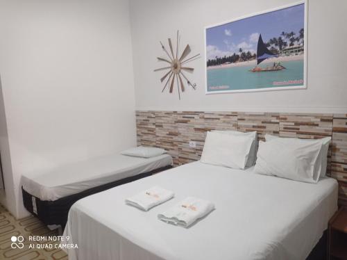 A bed or beds in a room at Pousada Marinah