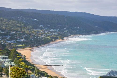 an aerial view of a beach with houses and the ocean at The George in Lorne