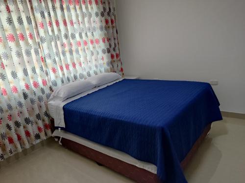 Cama pequeña en habitación con cortina en MINI DEPARTAMENTO LAS VEGAS, en Chimbote