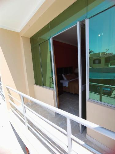 a balcony of a house with a view of a bedroom at Madison Suite in Tacna