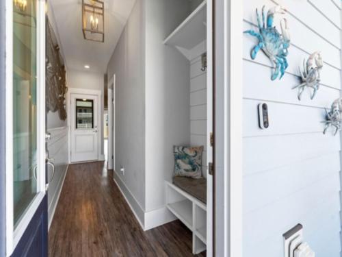 a hallway of a home with a door and a room with a hallway at Pelican Watch - Steps away from a beautiful beach in a prime location home in Carolina Beach