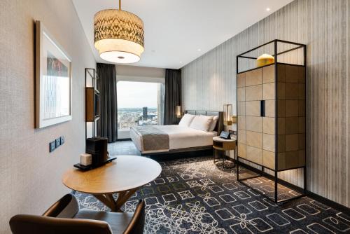 a hotel room with a bed and a table at InterContinental Perth City Centre by IHG in Perth