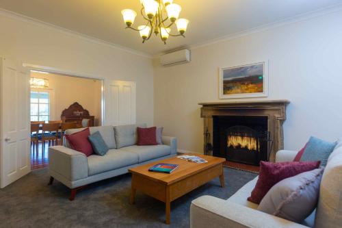 a living room with a couch and a fireplace at Staghorn Manor in Lovedale
