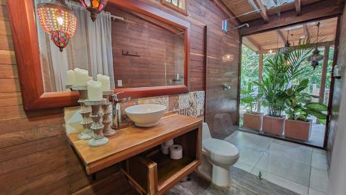 a bathroom with a sink and a toilet at Hotel Agualinda Doradal in Puerto Triunfo